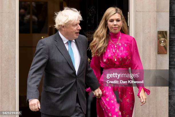 British Prime Minister Boris Johnson arrives with his wife Carrie Johnson as he prepares to deliver a farewell address before his official...