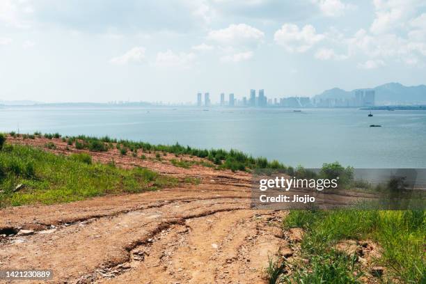 dirt road by sea - erosion stock pictures, royalty-free photos & images