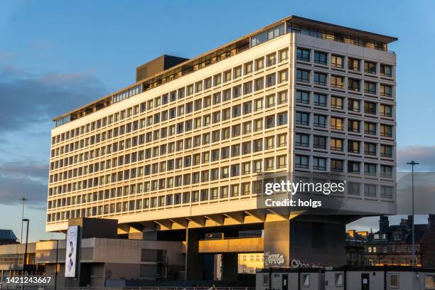 newcastle united kingdom modernist building currently undergoing renovation with the foundation structure being significantly smaller than the building it supports - office building exterior small stock pictures, royalty-free photos & images