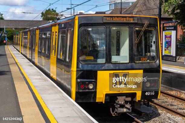 newcastle united kingdom metro train stopped at a station platform outside the city center with passengers visible onboard - tyne and wear stock pictures, royalty-free photos & images