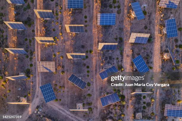 aerial view of an old abandoned solar panels farm (solar panel) with sunlight at sunset 03 - maria castellanos fotografías e imágenes de stock