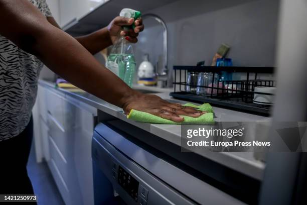 Domestic worker cleans the kitchen counter on the day that unemployment benefits for domestic workers were approved, on September 6 in Madrid, Spain....