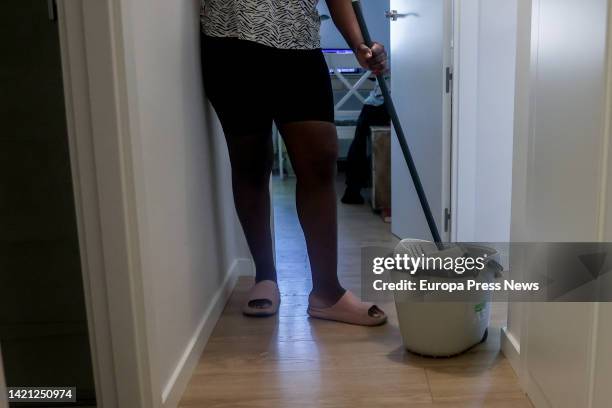 Domestic worker cleans with a mop on the day that unemployment benefits for domestic workers were approved, on September 6 in Madrid, Spain. The...