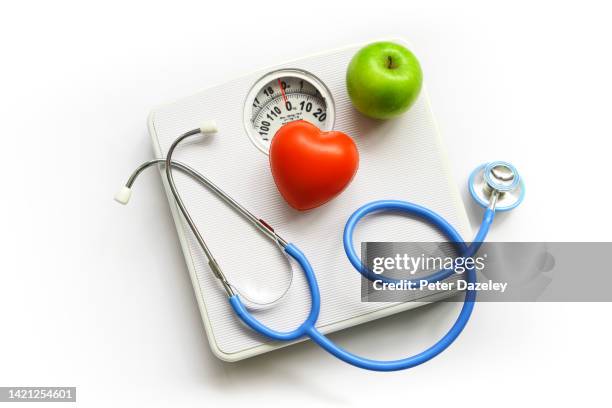 stethoscope, apple and heart - heart disease prevention stock pictures, royalty-free photos & images