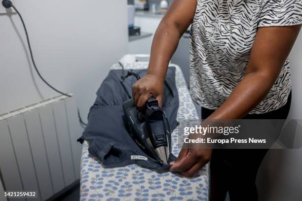 Domestic worker irons a T-shirt on the day that unemployment benefits for domestic workers were approved, on September 6 in Madrid, Spain. The...