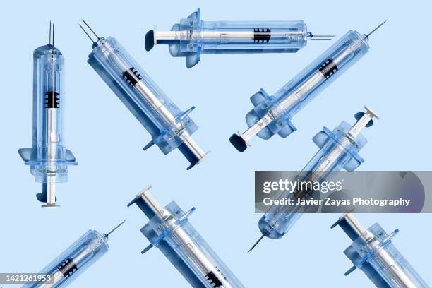 some syringes on blue background - steroids stock pictures, royalty-free photos & images