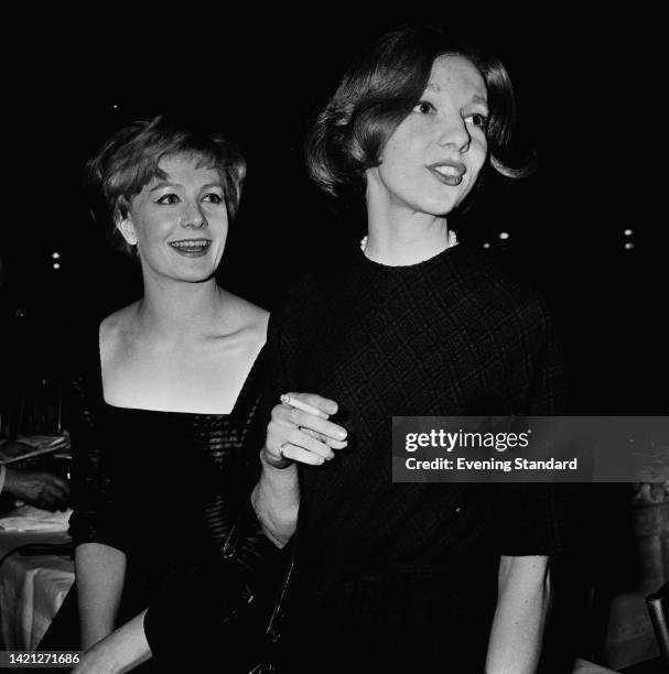 British actress Vanessa Redgrave and British actress Anna Massey , holding a cigarette, both smiling, attend an event, United Kingdom, 20th November...