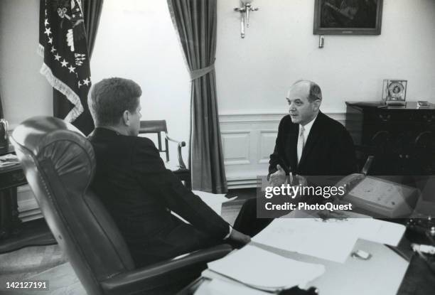 American President John F. Kennedy talks to Secretary of State Dean Rusk in the White Houses Oval Office, Washington DC, 1961.