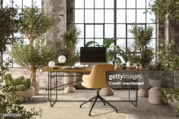 environmentally friendly office space with table, office chair, desktop computer and plants - bokeh computer screen stock pictures, royalty-free photos & images