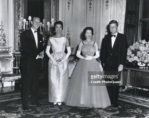At Buckingham Palace during a banquest held in his honor, American President John F. Kennedy and his wife, First Lady Jacqueline Kennedy , pose with...