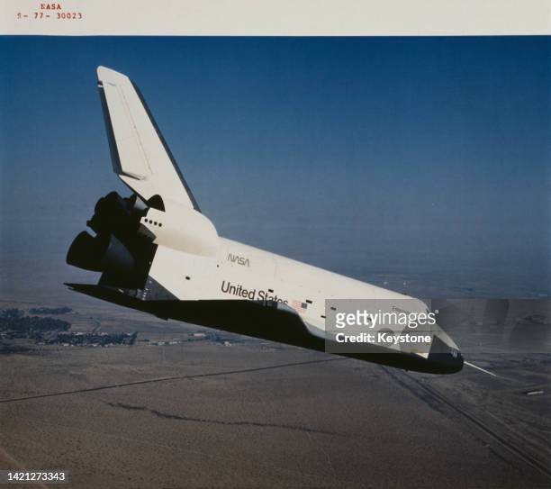 The Space Shuttle Enterprise , having separated from the NASA 905, a 747 carrier aircraft, glides toward its first hard surface landing, during the...
