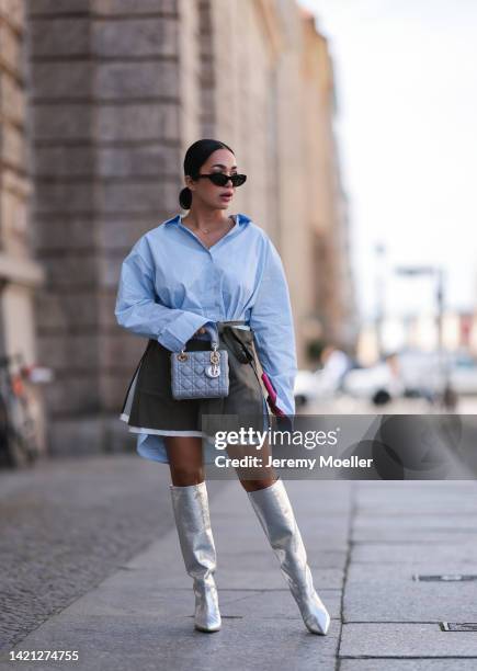 Farah Assaad is seen wearing black Balenciaga shades, a light blue oversize shirt, grey wrap mini skirt, a light blue leather Lady Dior bag, silver...