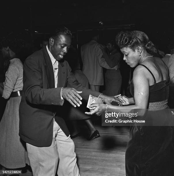 Man and woman dancing at the Savoy Ballroom on Lenox Avenue, in the Harlem neighborhood of Manhattan, New York City, New York, 1947.