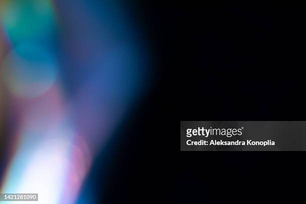 colorful neon holographic light leaks on black background - led street lighting stock-fotos und bilder
