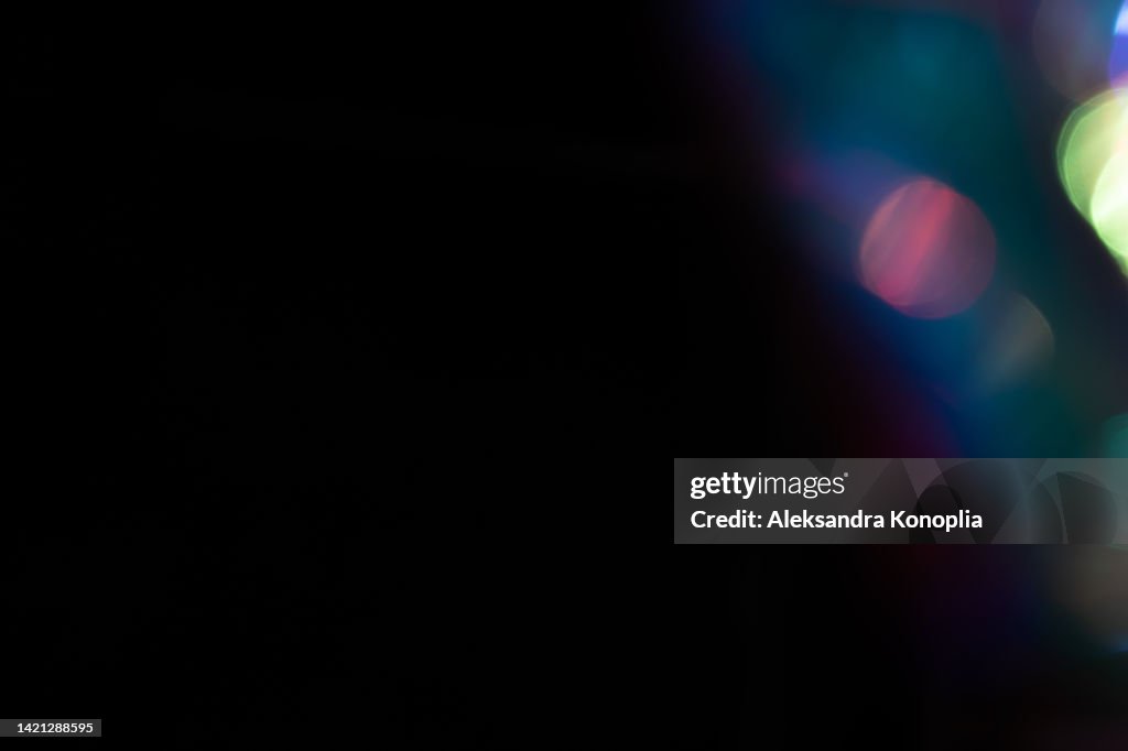 Colorful neon holographic light leaks on black background