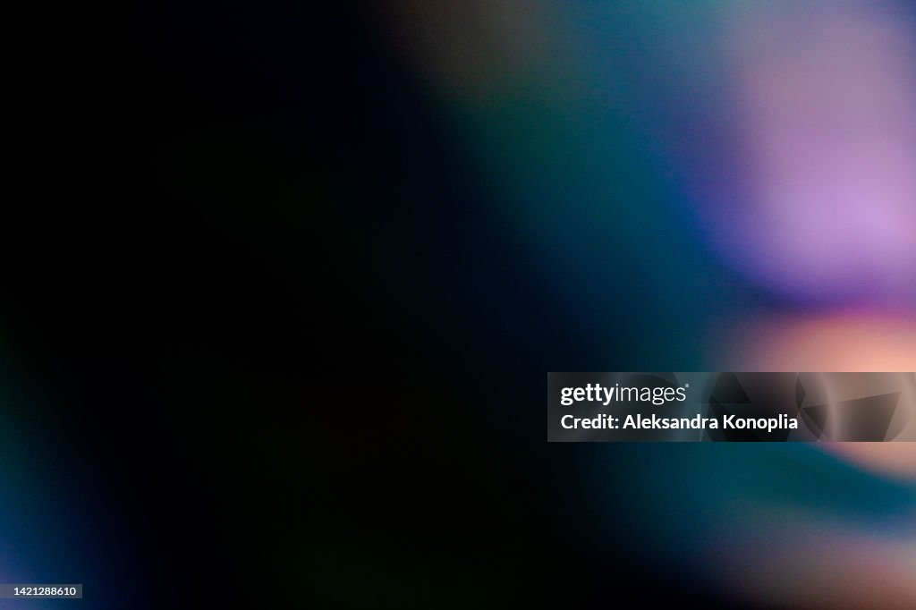 Colorful neon holographic light leaks on black background