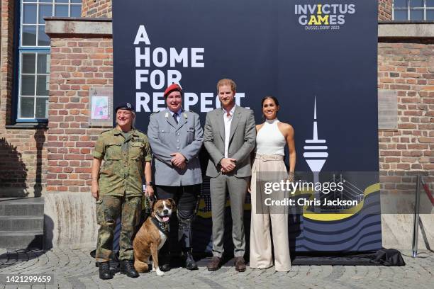 Prince Harry, Duke of Sussex and Meghan, Duchess of Sussex pose with competitors from the previous Invictus games during the Invictus Games...