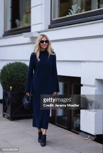 Sue Giers is seen wearing a black Miu Miu bag, black Celine sunglasses, Jimmy choo black heels, SoSue blue dress, 360cashmere Poncho on September 02,...