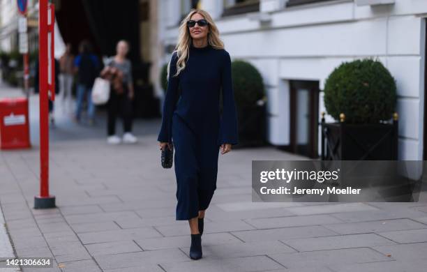 Sue Giers is seen wearing a black Miu Miu bag, black Celine sunglasses, Jimmy choo black heels, SoSue blue dress, 360cashmere Poncho on September 02,...