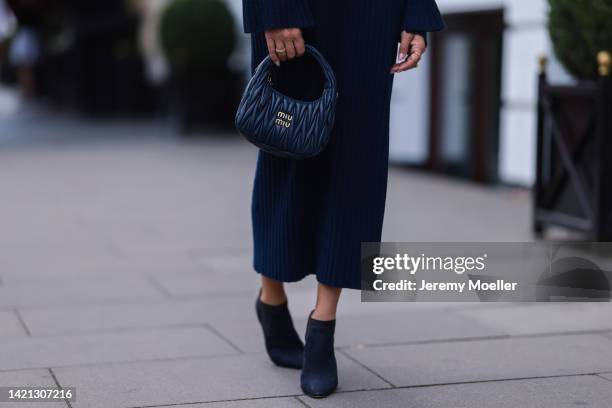 Sue Giers is seen wearing a black Miu Miu bag, black Celine sunglasses, Jimmy choo black heels, SoSue blue dress, 360cashmere Poncho on September 02,...