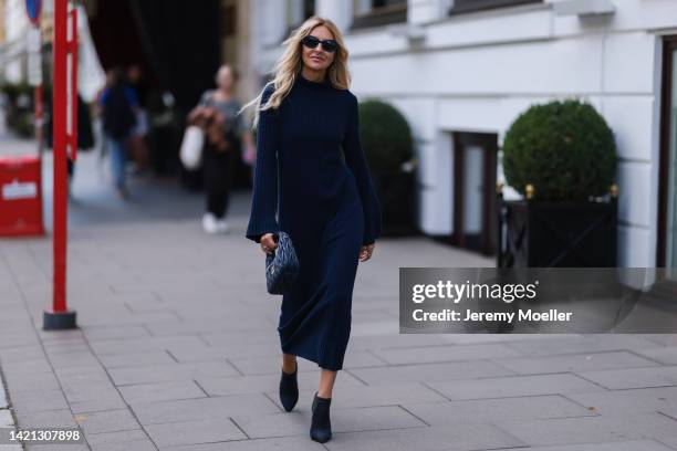 Sue Giers is seen wearing a black Miu Miu bag, black Celine sunglasses, Jimmy choo black heels, SoSue blue dress, 360cashmere Poncho on September 02,...