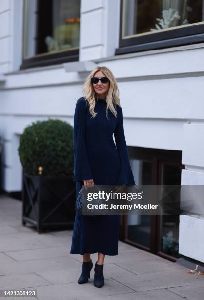 Sue Giers is seen wearing a black Miu Miu bag, black Celine sunglasses, Jimmy choo black heels, SoSue blue dress, 360cashmere Poncho on September 02,...