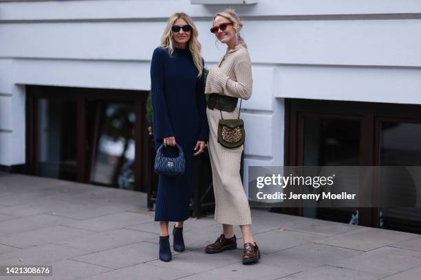 Sue Giers is seen wearing a black Miu Miu bag, black Celine sunglasses, Jimmy choo black heels, SoSue blue dress, 360cashmere Poncho and Kate...