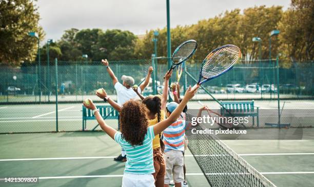 children learning tennis in fitness class at school, training for sports game on court and kids in line for sport education. students, friends and athlete playing on playground for competition - tennisser stockfoto's en -beelden