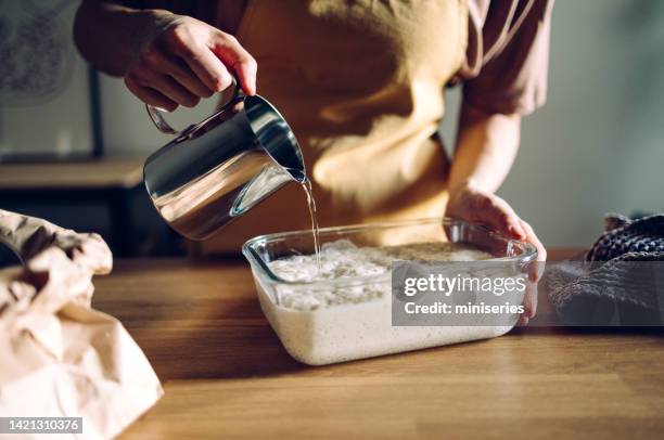 anonymous woman holding a glass bowl with dough - yeast stock pictures, royalty-free photos & images