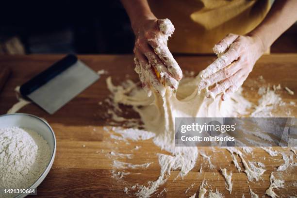 anonymous female preparing sourdough bread at home - kneading stock pictures, royalty-free photos & images