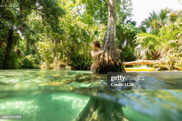 young woman playing at a river in florida - orlando florida vacation stock pictures, royalty-free photos & images