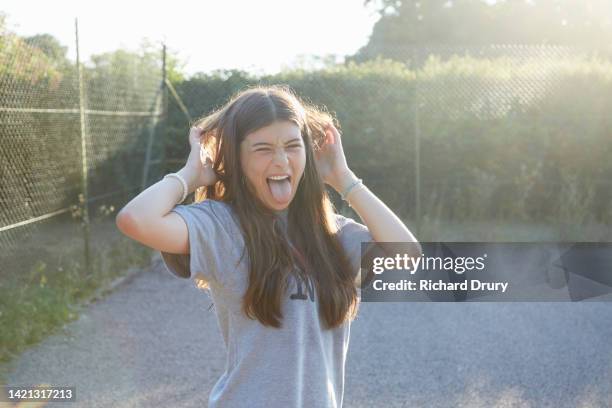 teenage girl pulling a face - 14 year old brunette girl stock pictures, royalty-free photos & images