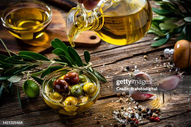 organic extra virgin olive oil and olives - olive oil bowl stock pictures, royalty-free photos & images