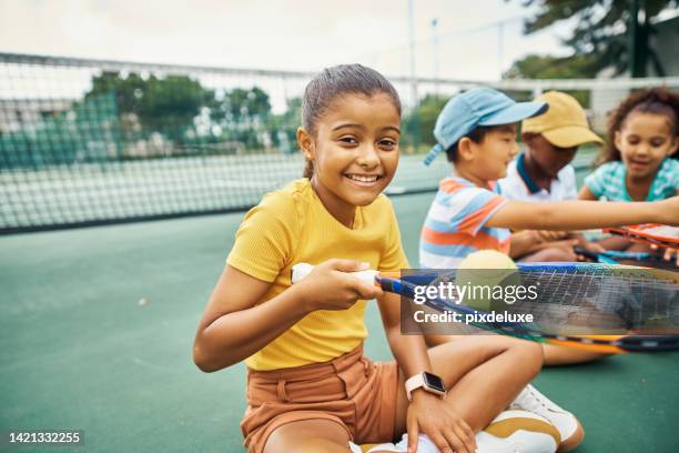 tennis student, team exercise and training of a girl from india happy with children students. portrait of a indian child with a smile ready to start sports kids workout and fitness on a sport court - training camp stock pictures, royalty-free photos & images