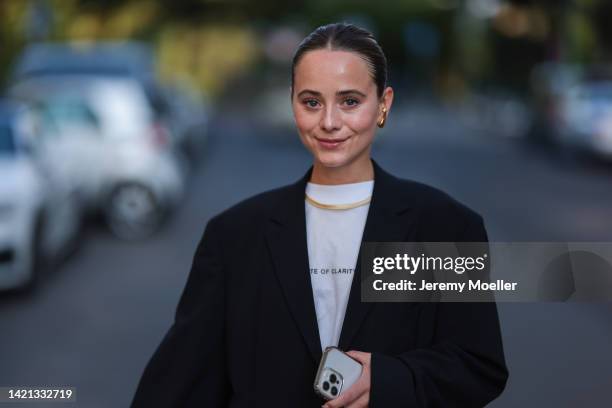 Jana Aasland is seen wearing gold earrings, gold necklace, white t-shirt and a black oversize blazer, outside Danny Reinke, during Berlin Fashion...