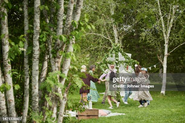 people dancing around maypole - maibaum stock-fotos und bilder