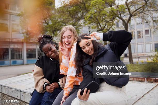 three young female students taking selfie at campus - school yard stock pictures, royalty-free photos & images