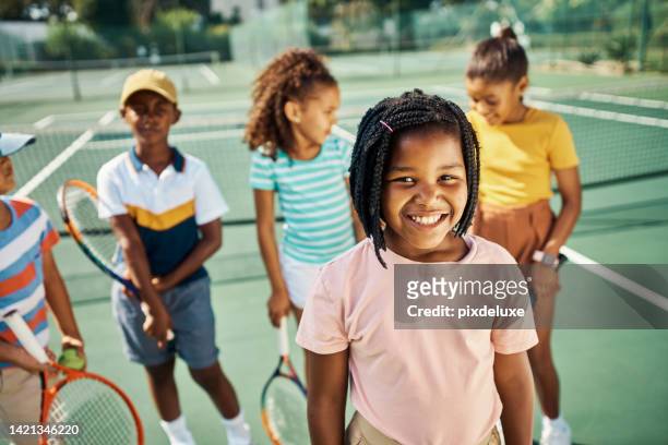 future girl tennis player, sports star training class with friends and group of kids stand on outdoor court together. smile of cute young black child, happy learning fitness activity and summer sun - tennis boy stock pictures, royalty-free photos & images