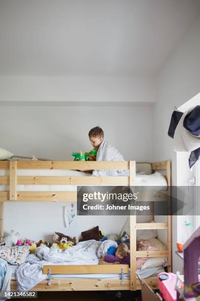 brothers lying in bunk bed - kids in bunk bed stock pictures, royalty-free photos & images