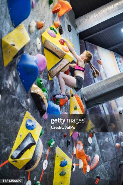 little girl training on rock-climbing wall - extreem weer stock pictures, royalty-free photos & images