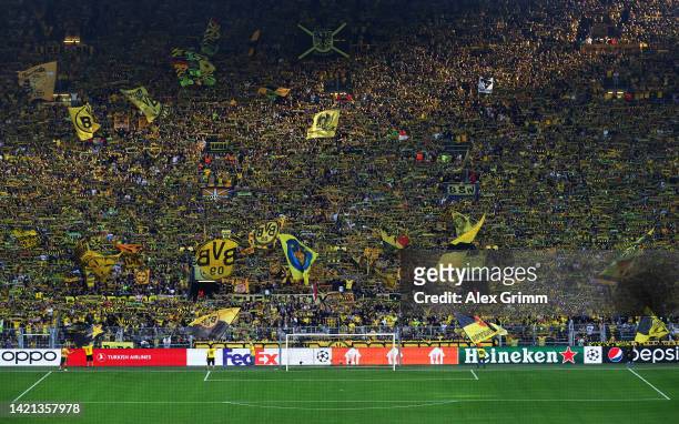 Borussia Dortmund fans show their support with scarves and flags prior to the UEFA Champions League group G match between Borussia Dortmund and FC...