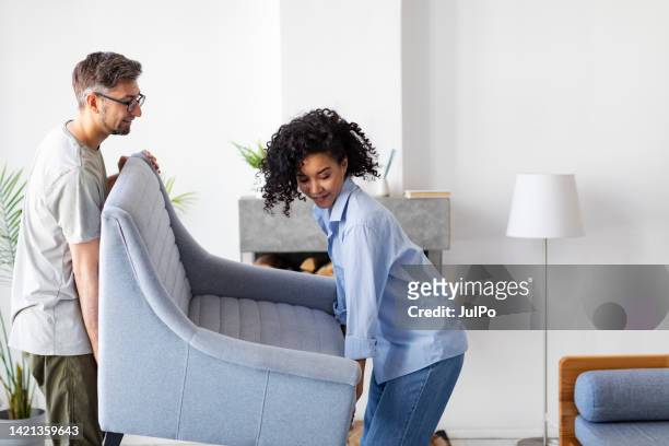 young adult multiracial couple moving to new flat - millennial home ownership stock pictures, royalty-free photos & images