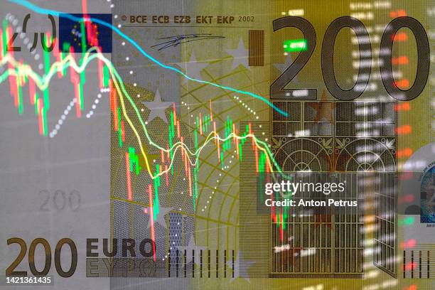 200 euro banknote on the background of  stock charts. economic crisis in eu - inflation euro stock-fotos und bilder