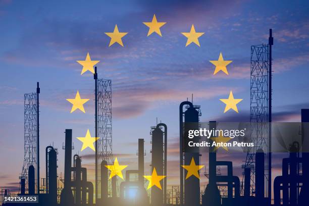 energy crisis in europe. liquid natural gas plant on the background of the eu flag - gas stockfoto's en -beelden
