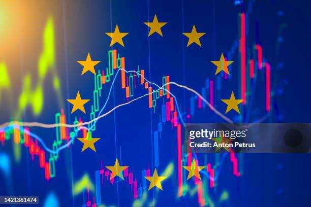 eu flag on the background of  stock charts. economic crisis in eu - punishment stocks stock-fotos und bilder