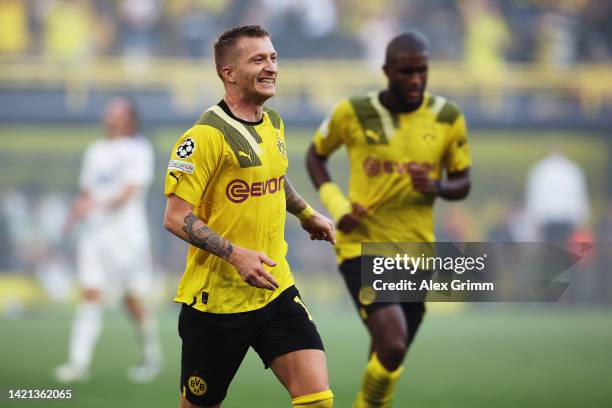 Marco Reus of Borussia Dortmund celebrates after scoring their team's first goal during the UEFA Champions League group G match between Borussia...