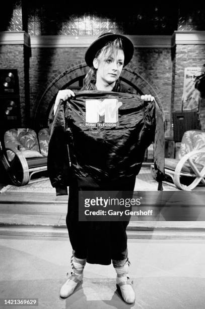 View of British Pop musician Boy George , of the group Culture Club, posing with a MTV-branded jacket during an interview on MTV at Teletronic...