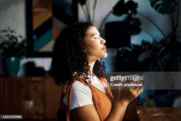 relax, peace and coffee with a woman drinking a drink of caffeine and meditating in her home with her eyes closed. mental health, wellness and zen with a young female enjoying calm, quiet tranquility - saúde mental imagens e fotografias de stock