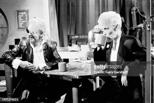 View of English musician Dave Stewart and Scottish musician Annie Lennox, both of the group Eurythmics, as they sit in a diner's booth during an...
