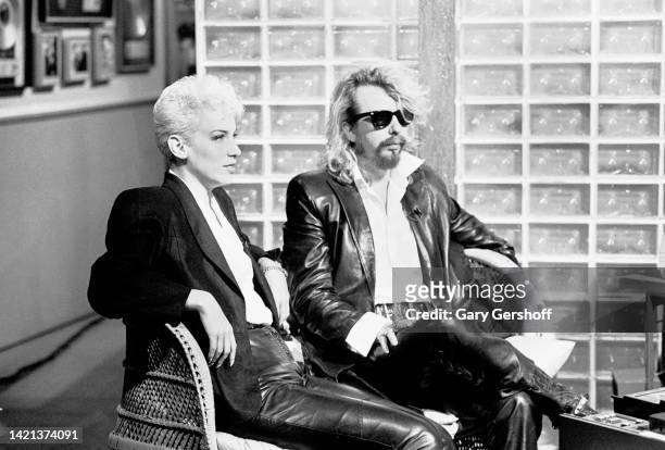 View of Scottish musician Annie Lennox and English musician Dave Stewart, both of the group Eurythmics, as they sit in chairs during an interview on...
